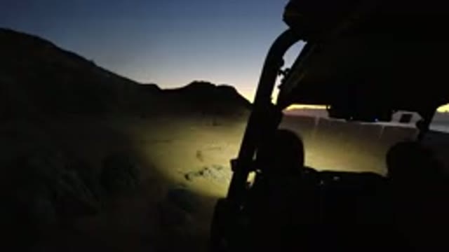 LOS CABOS MEXICO-2019: Person Riding ATV on Mountain Hillside at Dusk