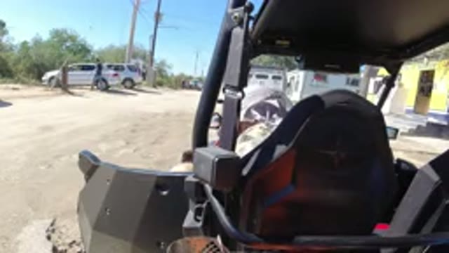 LOS CABOS MEXICO-2019: Man In A Vehicle In A Dusty Parking Lot Empties His Shoe