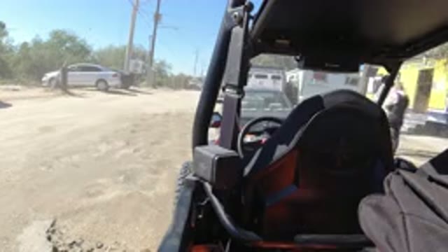 LOS CABOS MEXICO-2019: View Of Men Outside A Yellow Building From A Jeep In The