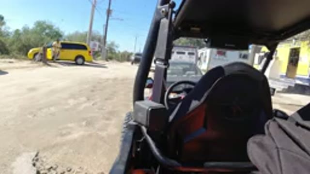 LOS CABOS MEXICO-2019: Man in Wrangler Standing Near Black Truck with Passersby