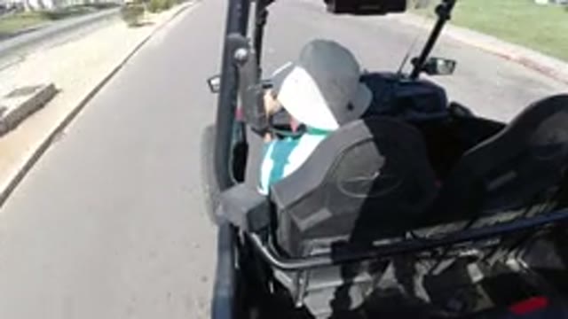 LOS CABOS MEXICO-2019: Driving A Golf Cart On The Highway On A Sunny Day