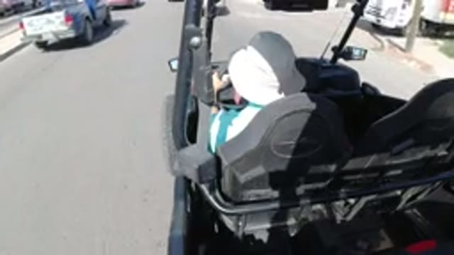LOS CABOS MEXICO-2019: Man With A Hat Slowly Driving Through The Street Due To