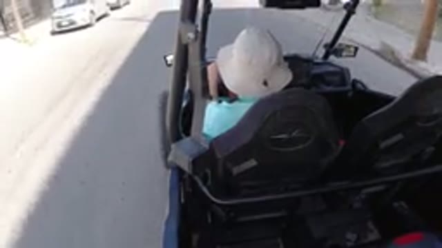 LOS CABOS MEXICO-2019: A Man Driving A Golf Cart Through The City On A Sunny