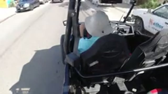 LOS CABOS MEXICO-2019: Person Wearing White Hat Driving Down Sunny Road