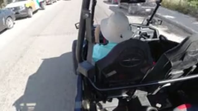 LOS CABOS MEXICO-2019: A Person Driving a Vehicle on the Road Wearing a Hat