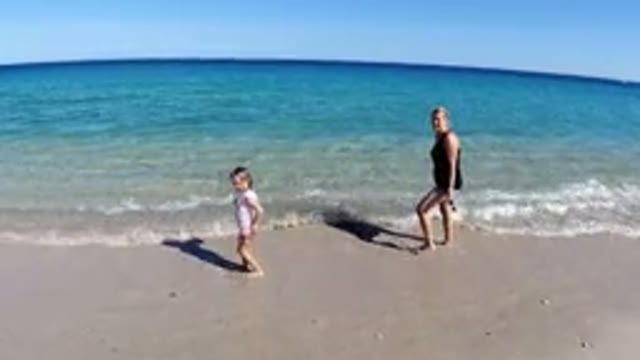 LOS CABOS MEXICO-2019: A Woman And Child Play In The Water At The Beach