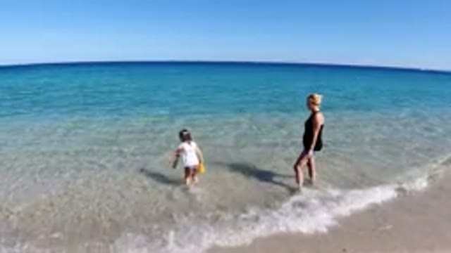 LOS CABOS MEXICO-2019: A Mother And Her Little Daughter Enjoy The Waves At The