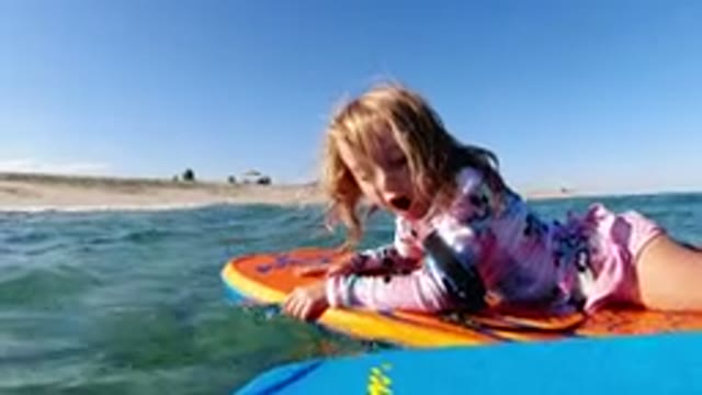 LOS CABOS MEXICO-2019: Little Girl On Boogie Board In The Ocean Close To Shore