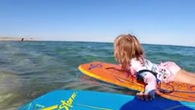 LOS CABOS MEXICO-2019: A Little Girl Wearing Flowery Swimming Dress Is Holding