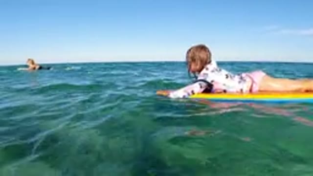LOS CABOS MEXICO-2019: Little Girl Trying To Learn How To Surf On Her Board