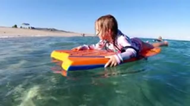 LOS CABOS MEXICO-2019: A Kid Is Having Fun On The Beach The Kid Is Floating In A