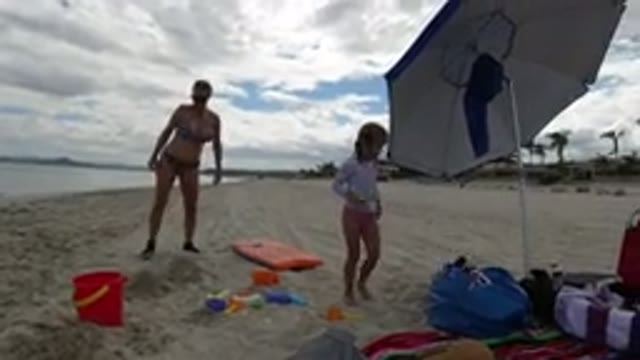 LOS CABOS MEXICO-2019: A Mom And Daughter Playing On The Beach Side