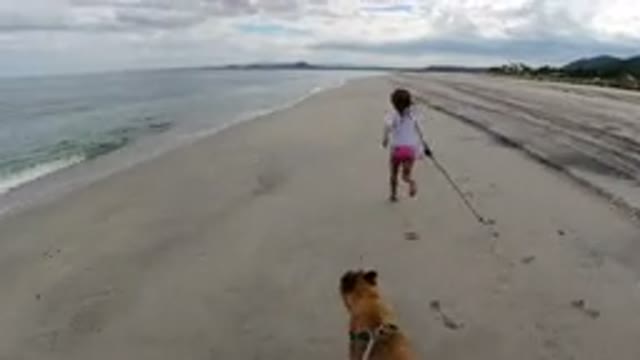 LOS CABOS MEXICO-2019: Young Girl And Her Dog Running On A Beautiful Sand Beach
