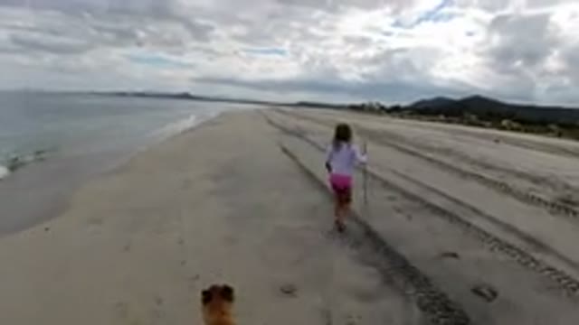LOS CABOS MEXICO-2019: Girl In White Shirt And Pink Pants Run With Stick On The Beach