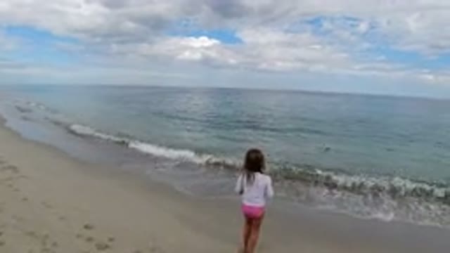 LOS CABOS MEXICO-2019: Small Child Playing On The Beach Watching The Ocean Waves