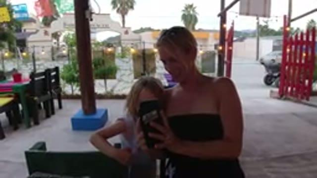 LOS CABOS MEXICO-2019: Girl Sitting Outside On A Business Patio Looking At A