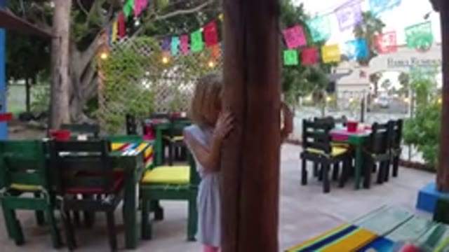 LOS CABOS MEXICO-2019: A Small Girl Playing Hide and Seek in a Tree