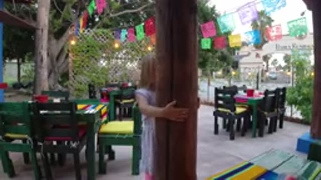 LOS CABOS MEXICO-2019: Girl Playing Outside Of A Restaurant She Is Hugging The Pole