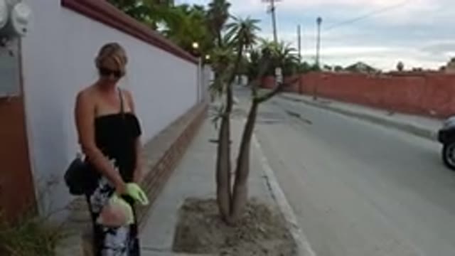 LOS CABOS MEXICO-2019: Little Blonde Girl Walking Down The Street With Her Mother