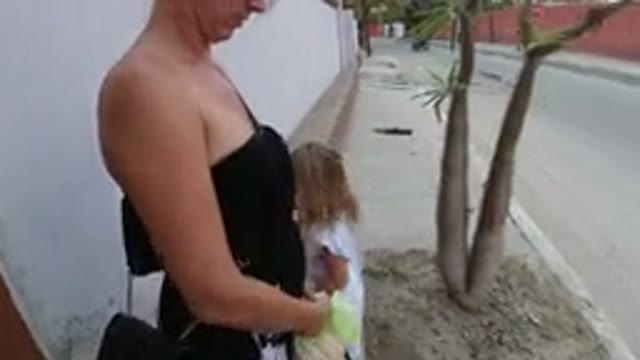 LOS CABOS MEXICO-2019: Little Girl Steps on Dirt and Rubs It Off Barefoot