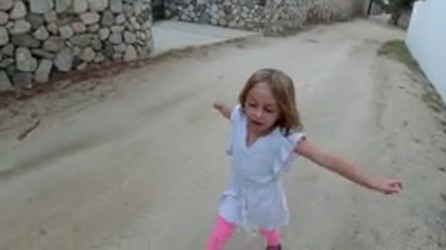 LOS CABOS MEXICO-2019: Small Girl in White Dress Walking with Lady in Black