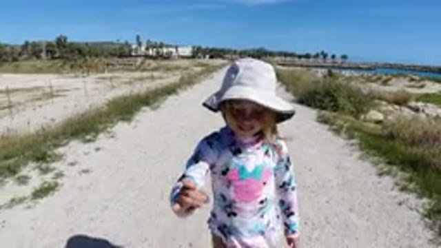 LOS CABOS MEXICO-2019: One Girl Wailing on Rough Road with Trees and Rocks