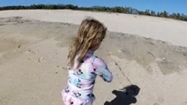 LOS CABOS MEXICO-2019: Blonde Headed Girl Singing and Walking on Warm Beach