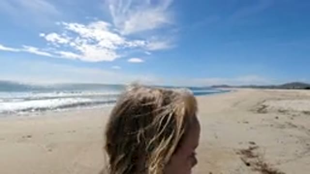 LOS CABOS MEXICO-2019: Girl Wipes Tears From Eyes As Walks By Ocean