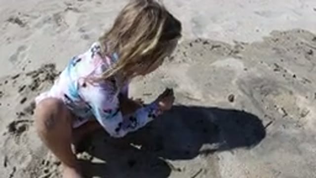 LOS CABOS MEXICO-2019: A Little Child Playing In The Sand On A Beautiful Day