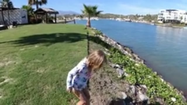 LOS CABOS MEXICO-2019: A Little Girl Is Walking Along The Shores Of A River In A