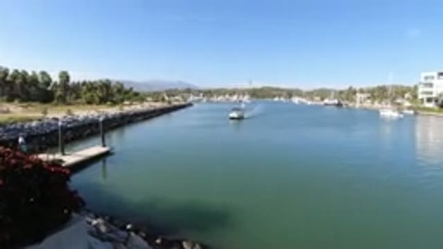 LOS CABOS MEXICO-2019: Boat Traverses A Canal In A Semi-Developed Area On A