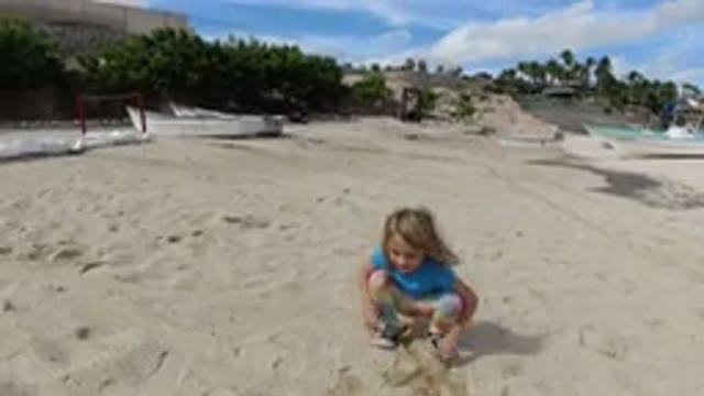 LOS CABOS MEXICO-2019: One Girl Playing On Sand In A Beach Side Boating Trees