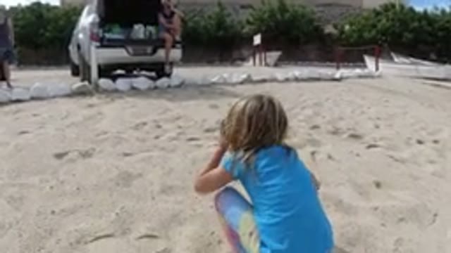 LOS CABOS MEXICO-2019: Little Girl Playing On The Beach Sand While Her Mother Watches