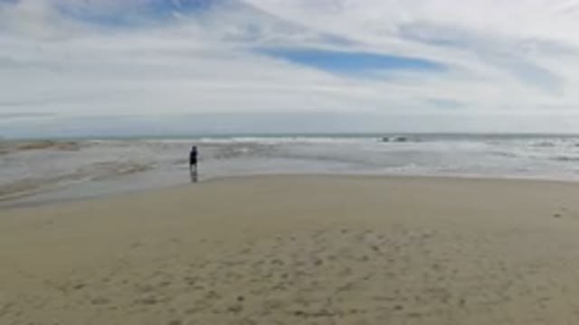 LOS CABOS MEXICO-2019: A Distant Person Stands On The Beach On A Cloudy Day