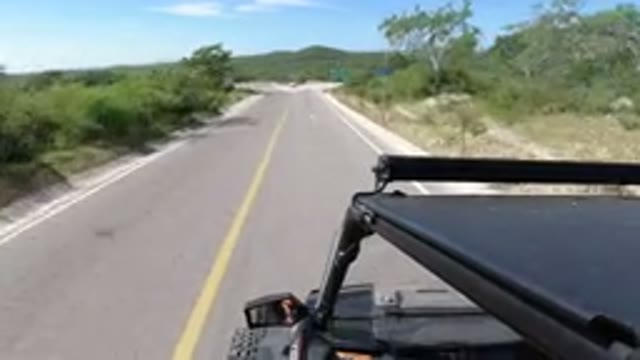 LOS CABOS MEXICO-2019: A Vehicle Driving On A Narrow Road On A Nice Day
