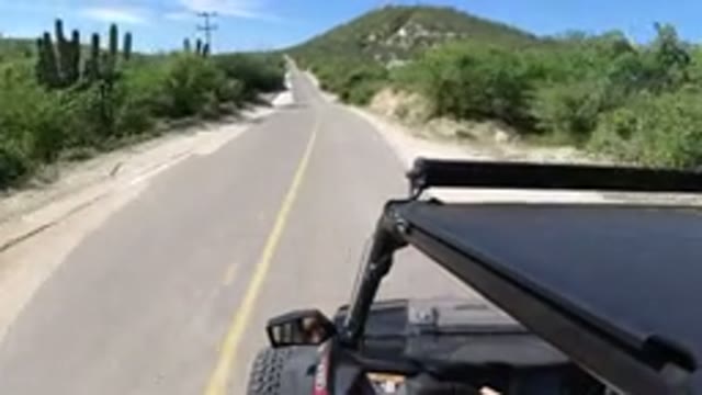 LOS CABOS MEXICO-2019: A Person Is Driving A Vehicle On A Narrow Road On A
