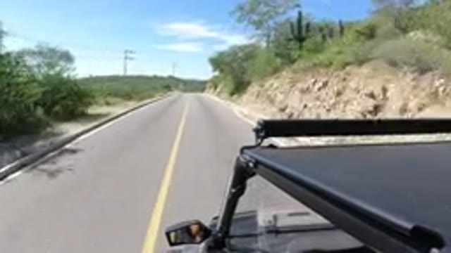 LOS CABOS MEXICO-2019: Driving Down An American Road In A Black Dune Buggy