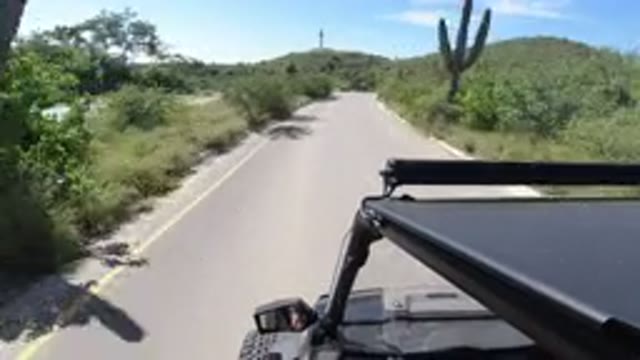 LOS CABOS MEXICO-2019: Driving Down Long Highway With Grassy Sides On Each Side