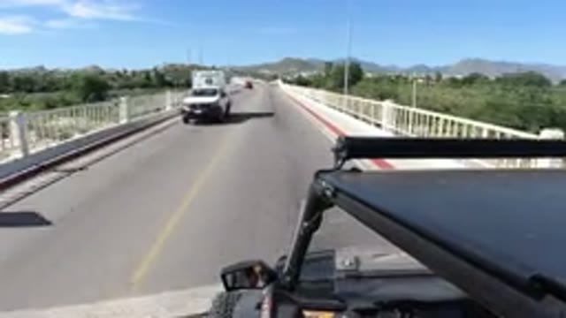 LOS CABOS MEXICO-2019: Person Driving Over A Bridge While Other Wranglers Pass