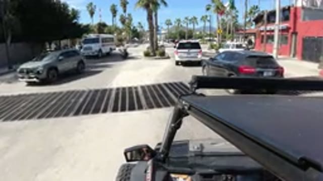 LOS CABOS MEXICO-2019: A Slow Moving Vehicle Navigates Through Traffic On A Busy