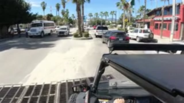 LOS CABOS MEXICO-2019: Someone Is Driving A Vehicle On A Busy Street Surrounded