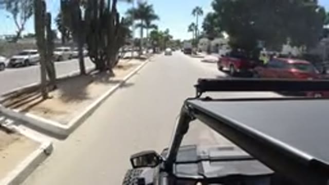 LOS CABOS MEXICO-2019: Person Driving Wrangler Through Street With Palm Trees