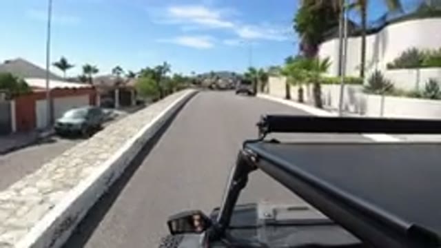 LOS CABOS MEXICO-2019: Camera Mounted On Top Of A Jeep Riding Down The Street