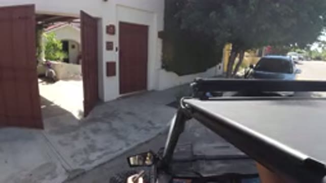 LOS CABOS MEXICO-2019: A Man Opening His House Gate With A Remote