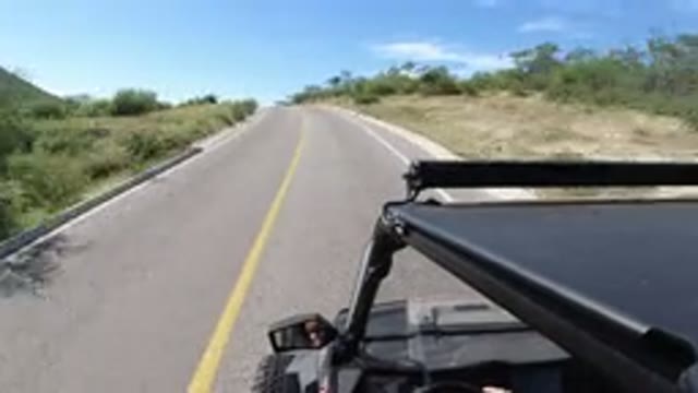 LOS CABOS MEXICO-2019: A Black Vehicle Drives On A Paved Two-Way Highway In A