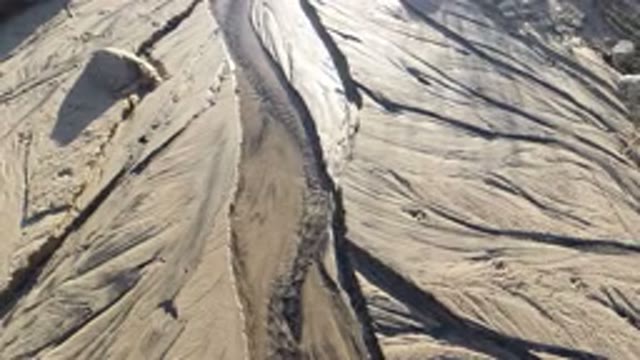 LOS CABOS MEXICO-2019: Filming a Small River Flowing Over Stone or Sand