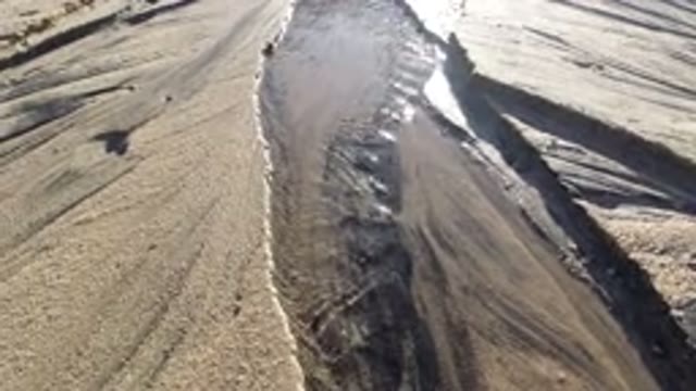 LOS CABOS MEXICO-2019: Stream Of Water Flowing Gently Through Sandy Area