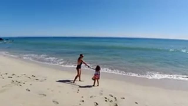 LOS CABOS MEXICO-2019: Woman And Child Hold Hands As They Look Out To Beach With