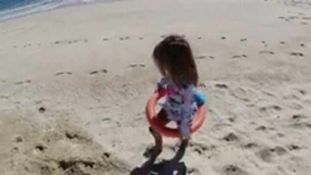 LOS CABOS MEXICO-2019: Young Girl Walking On A Sandy Ocean Beach With A Toy