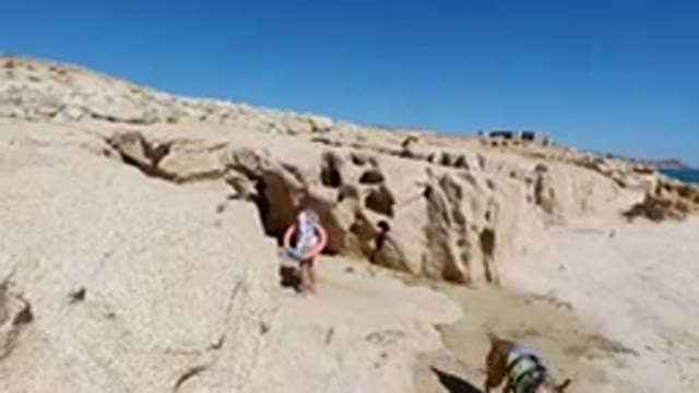 LOS CABOS MEXICO-2019: A Little Girl With Water Tube Is Walking On Beach Near